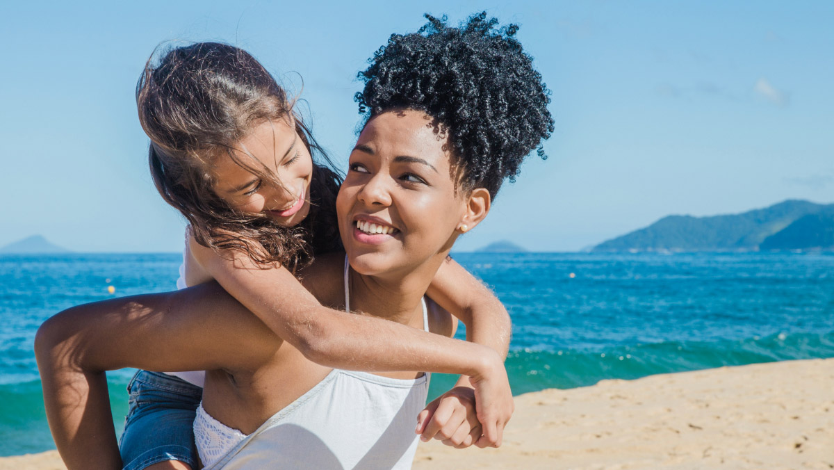a child piggybacking a ride on a sunny beach
