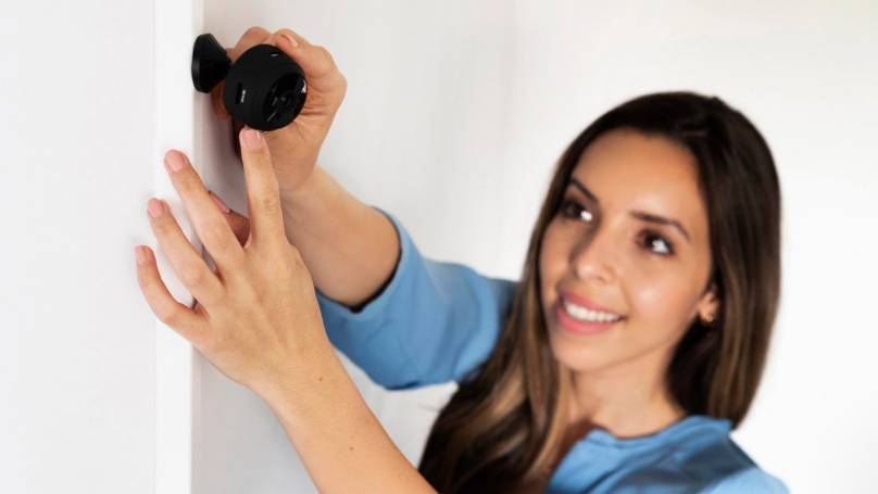 woman aligning her security camera