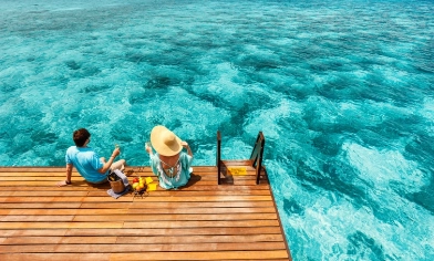 a couple relaxing by the sea with a picnic