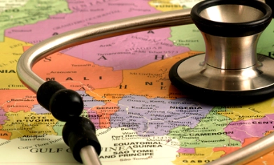 Doctor stethoscope resting on top of a world map
